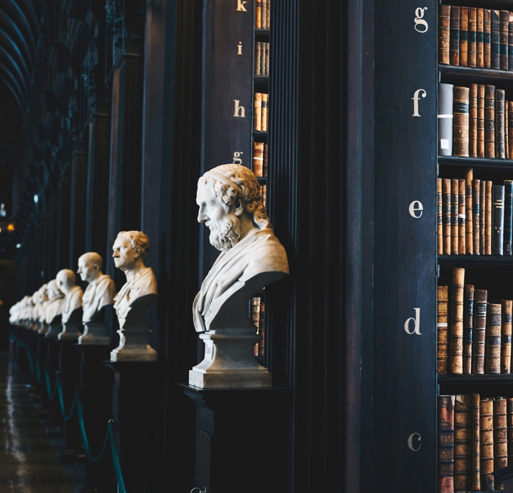 Library stacks with marble busts